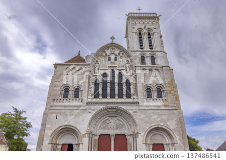 Vezelay basilica showcasing its elaborate Romanesque facade under a cloudy sky Vezelay basilica showcasing its elaborate Romanesque facade under a cloudy sky 137486541