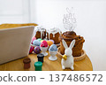 A festive scene with traditional Easter cakes, colorful painted eggs, and small paint pots, suggesting a creative holiday preparation 137486572