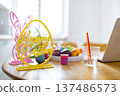 A bright and cheerful scene depicting the preparation for Easter egg decorating with colorful eggs and festive decorations 137486573
