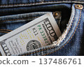 Dollar money in the pocket of jeans. Banknote One hundred dollar. 137486761