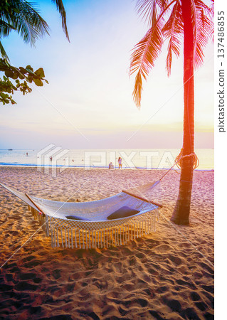 Hammock on sea beach on sunset. People on seaside. Island holiday. Hammock on sea beach on sunset. People on seaside. Island holiday. 137486855
