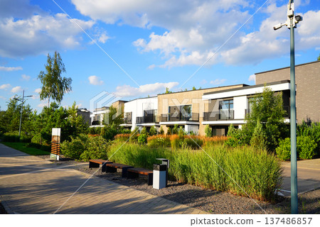 Modern Residential Area With Lush Landscaping at townhouse. Residential neighborhood Modern Residential Area With Lush Landscaping at townhouse. Residential neighborhood 137486857