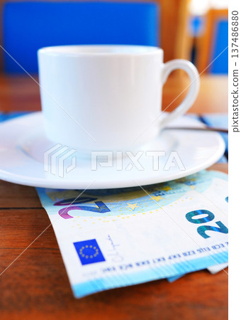 Coffee cup on table with Euro money bill in cafe. Payment coffee drink on breakfast. EC Bill money  137486880
