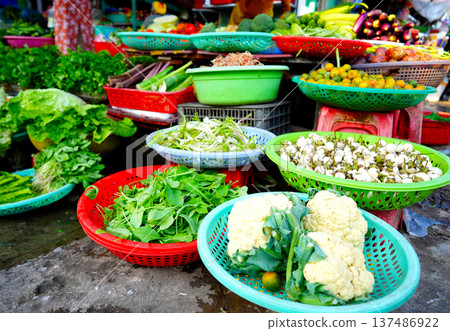 Vegetables market. Vendors display various types of fresh vegetables in baskets for sale Vegetables market. Vendors display various types of fresh vegetables in baskets for sale 137486922