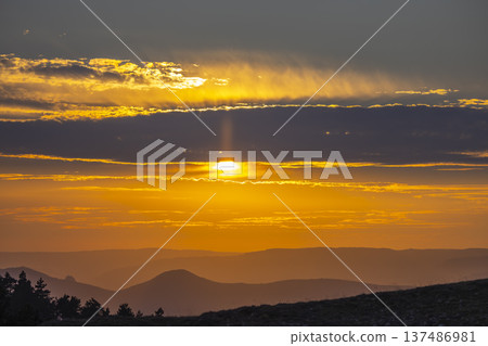 Golden sun setting over layered mountains in Navarra, Spain Golden sun setting over layered mountains in Navarra, Spain 137486981