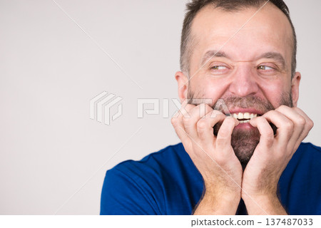 Man biting his nails 137487033