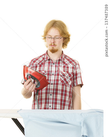 Man about to do ironing Man about to do ironing 137487389