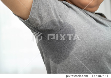 Sweaty underarms, Asian woman with sweat on clothes under armpit. Sweaty underarms, Asian woman with sweat on clothes under armpit. 137487561