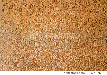 Abstract stone carving geometric floral pattern ancient temple wall texture bas relief detailed craft historic art background design architecture religion symbol weathered 137487615