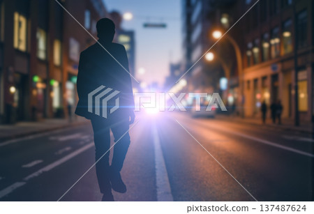 Silhouette of mysterious man walking on city street at night with bright car headlights, a concept for urban mystery story Silhouette of mysterious man walking on city street at night with bright car headlights, a concept for urban mystery story 137487624