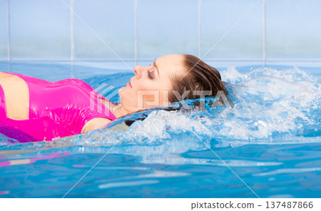 Beautiful woman swimming in pool 137487866