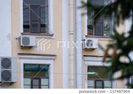 air conditioning on facade of building, air cooling in hot weather.  137487904