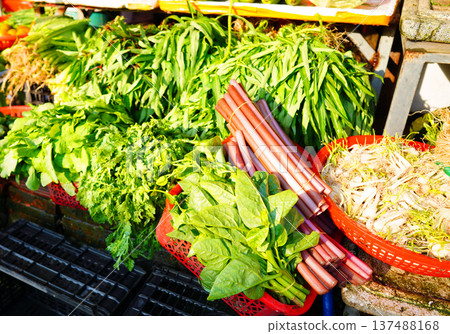 Vegetables for sale at local market. Vendors display various types of fresh vegetables  137488168
