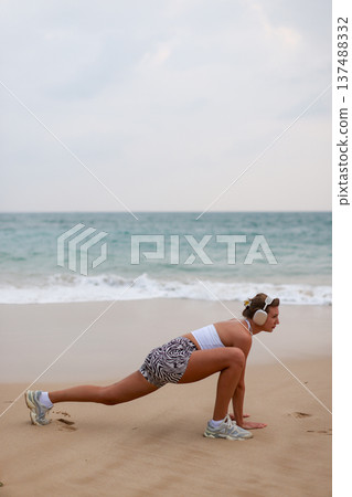 Runner On Beach. Dedicated Athlete Practices Endurance By Jogging Solitary Along Tranquil Ocean Coast Runner On Beach. Dedicated Athlete Practices Endurance By Jogging Solitary Along Tranquil Ocean Coast 137488332