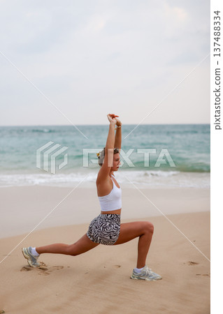 Female Performing Mobility Exercise Outdoors. Woman Engaged In Balance And Strength Training Outdoors 137488334