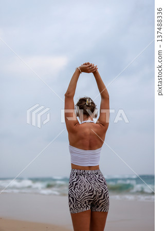 Female Performing Mobility Exercise Outdoors. Woman Engaged In Balance And Strength Training Outdoors 137488336