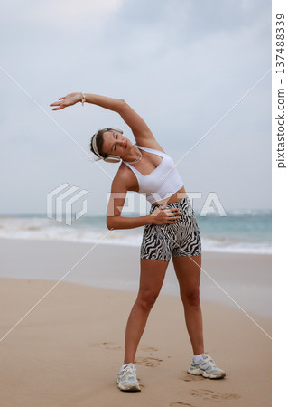 Female Performing Mobility Exercise Outdoors. Woman Engaged In Balance And Strength Training Outdoors Female Performing Mobility Exercise Outdoors. Woman Engaged In Balance And Strength Training Outdoors 137488339