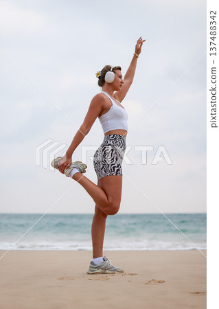 Female Performing Mobility Exercise Outdoors. Woman Engaged In Balance And Strength Training Outdoors Female Performing Mobility Exercise Outdoors. Woman Engaged In Balance And Strength Training Outdoors 137488342