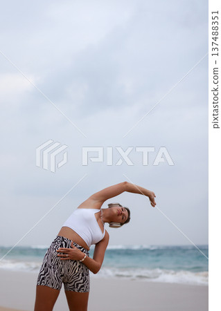 Female Performing Mobility Exercise Outdoors. Woman Engaged In Balance And Strength Training Outdoors 137488351