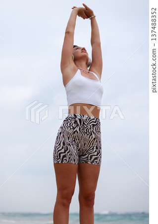 Female Performing Mobility Exercise Outdoors. Woman Engaged In Balance And Strength Training Outdoors Female Performing Mobility Exercise Outdoors. Woman Engaged In Balance And Strength Training Outdoors 137488352