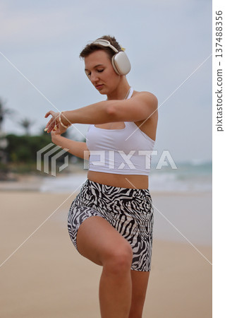 Female Performing Mobility Exercise Outdoors. Woman Engaged In Balance And Strength Training Outdoors Female Performing Mobility Exercise Outdoors. Woman Engaged In Balance And Strength Training Outdoors 137488356