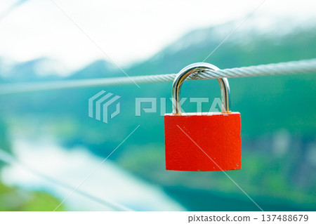 Red padlock and Geirangerfjord from Flydasjuvet viewpoint Norway Red padlock and Geirangerfjord from Flydasjuvet viewpoint Norway 137488679