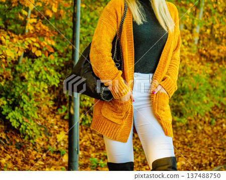 Woman wearing orange autumn cardigan outdoor Woman wearing orange autumn cardigan outdoor 137488750