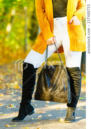 Woman wearing orange autumn cardigan outdoor Woman wearing orange autumn cardigan outdoor 137488753