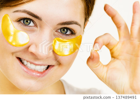 Woman with gold patches under eyes 137489491
