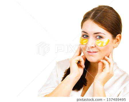 Woman with gold patches under eyes Woman with gold patches under eyes 137489495