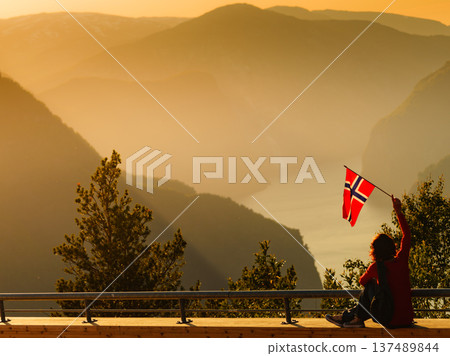 Tourist enjoy fjord view on Stegastein viewpoint Norway Tourist enjoy fjord view on Stegastein viewpoint Norway 137489844