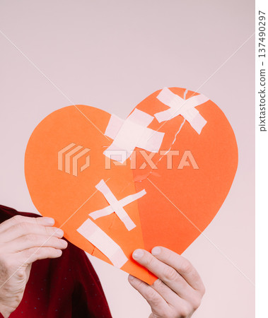 Man holding broken heart. Heartbreak Man holding broken heart. Heartbreak 137490297