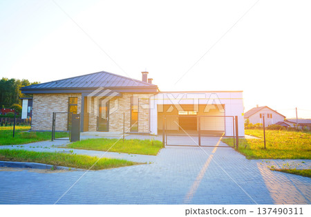 Suburban residential neighborhood, home on street, fence of single family home. Suburb family house 137490311