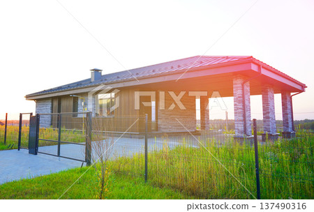 Suburban residential neighborhood, home on street, fence of single family home. Suburb family house 137490316