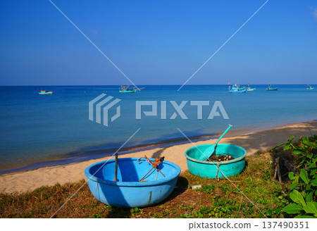 Fishing boat in sea on blue sky. View on ocean from beach. Fishing boats in sea along shore. Fishing boat in sea on blue sky. View on ocean from beach. Fishing boats in sea along shore. 137490351