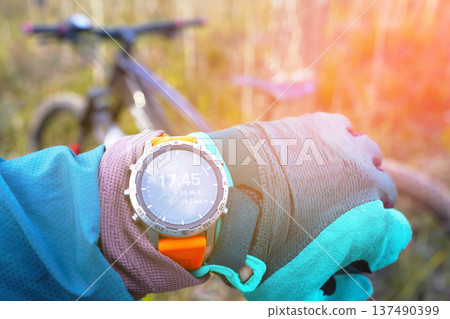 Smartwatch for mountain biking trails. Cyclist with GPS sports watch. Sport Watch for rider.  137490399