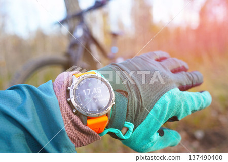 Smartwatch for mountain biking trails. Cyclist with GPS sports watch. Sport Watch for rider.  137490400