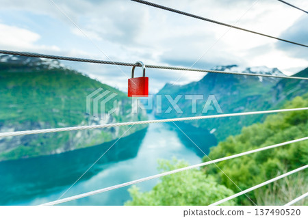 Red padlock and Geirangerfjord from Flydasjuvet viewpoint Norway 137490520