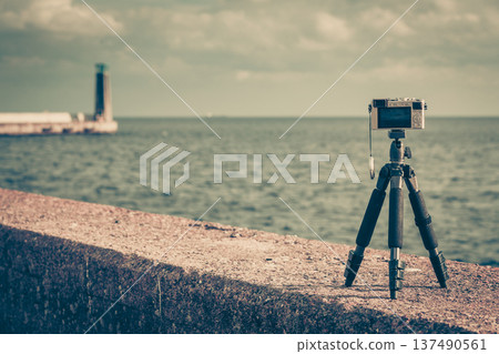 Photo camera on tripod in nature 137490561