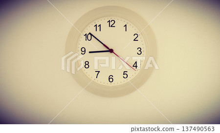 clock on wall showing nine hours clock on wall showing nine hours 137490563