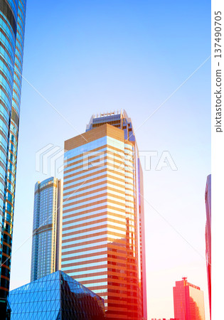 Skyscrapers in bright glass exteriors sunlight on sunset. Modern facade office buildings 137490705