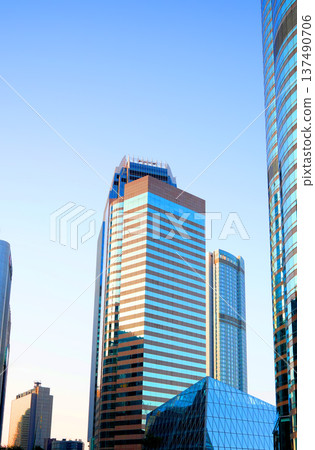Skyscrapers in bright glass exteriors sunlight on sunset. Modern facade office buildings 137490706