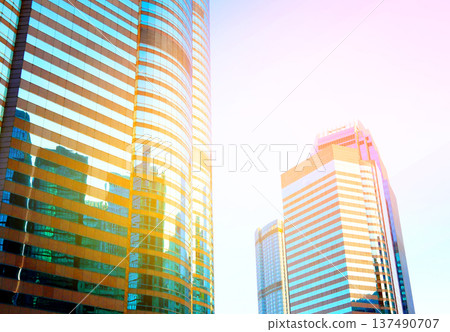 Skyscrapers in bright glass exteriors sunlight on sunset. Modern facade office buildings 137490707