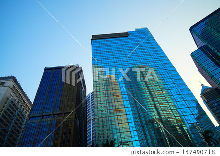 Skyscrapers in bright glass exteriors sunlight on sunset. Modern facade office buildings 137490718