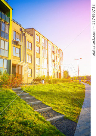 Steps stairs on pedestrian path to entrance of residential building. Eco-friendly condominium Steps stairs on pedestrian path to entrance of residential building. Eco-friendly condominium 137490738