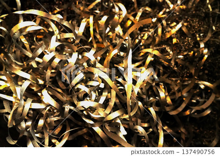 Steel scrap material recycling. Aluminum chip waste after machining metal parts on a cnc lathe Steel scrap material recycling. Aluminum chip waste after machining metal parts on a cnc lathe 137490756