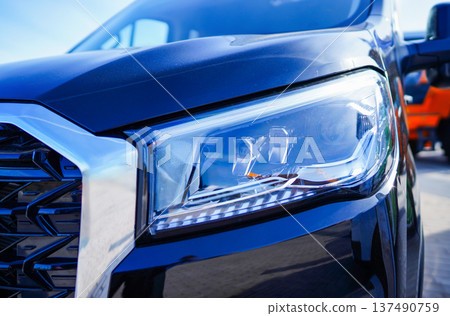 Headlight. LED headlamp of a modern car. Frontal lighting of highway vehicles Headlight. LED headlamp of a modern car. Frontal lighting of highway vehicles 137490759