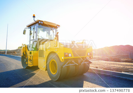 Road Asphalting construction. Asphalt paving repair. Vibrator compactor machine on roadworks Road Asphalting construction. Asphalt paving repair. Vibrator compactor machine on roadworks 137490778