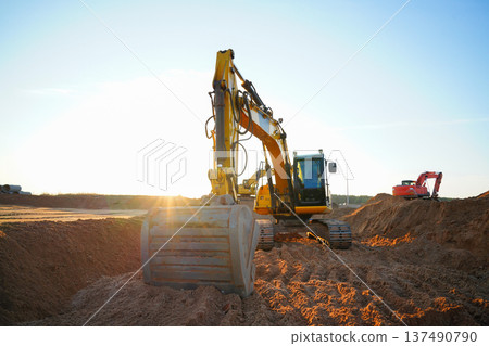 Excavator earthworks on construction site. Sewer line repair. Excavator groundwork water line repair Excavator earthworks on construction site. Sewer line repair. Excavator groundwork water line repair 137490790