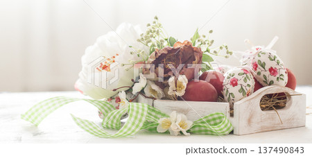 Easter background with a basket and red eggs with flowers Easter background with a basket and red eggs with flowers 137490843